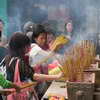 Burning incense sticks at Wong Tai Sin Temple